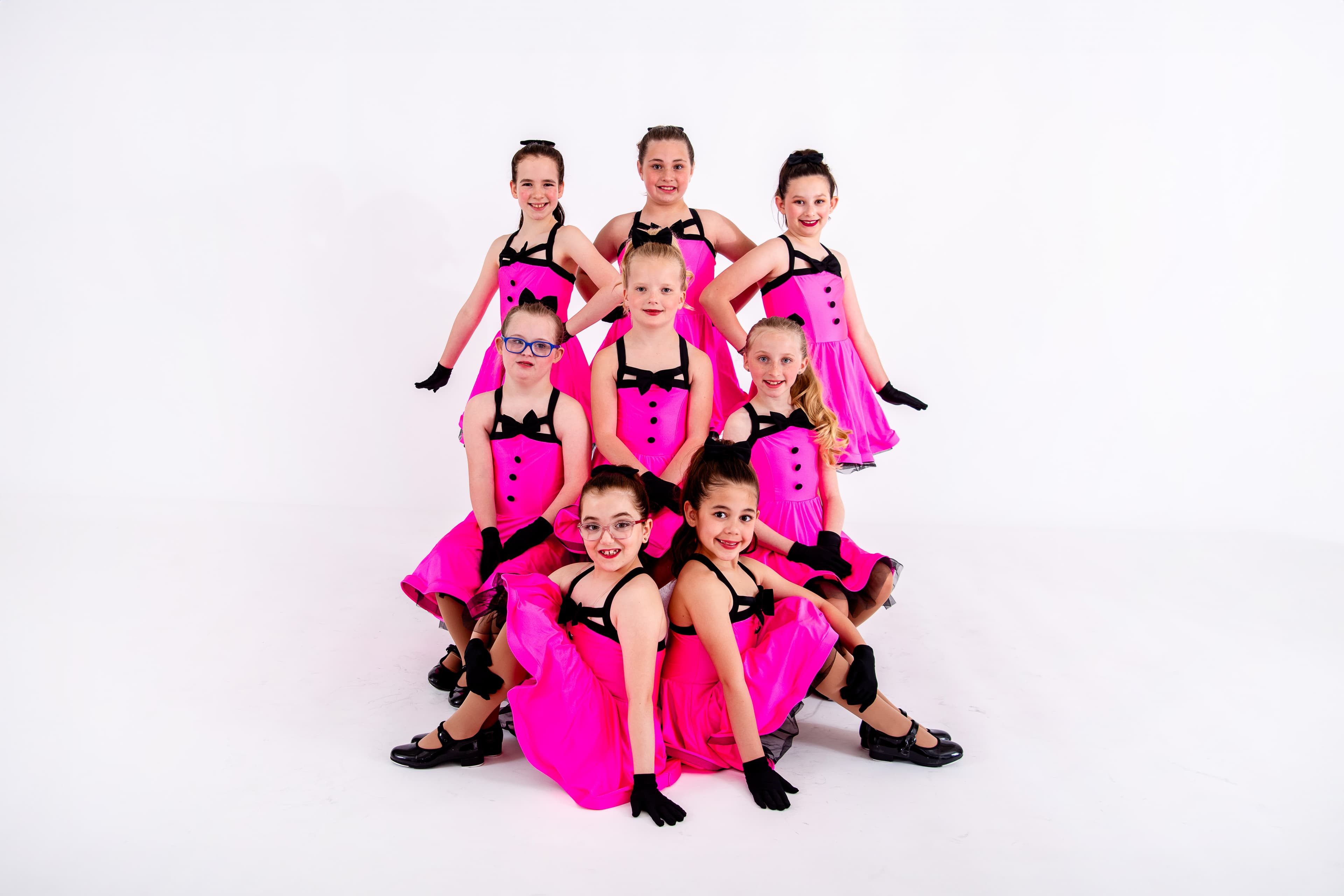 Musical theater dancers in pink costumes