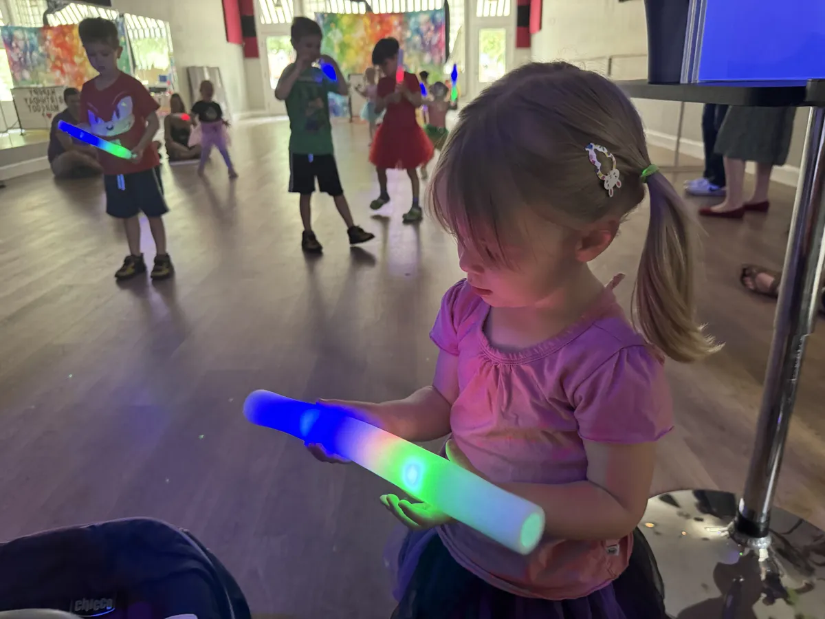 Kids with glow sticks dancing at a birthday party
